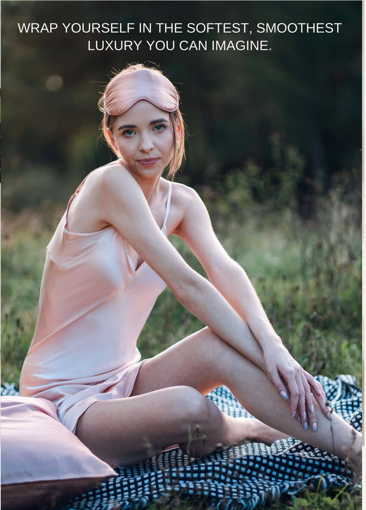 Woman wearing pink silk dress and eye mask having a picnic