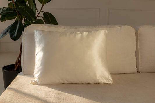 Woman wearing Silk Closet silk pyjamas lying on silk pillow with eye mask on