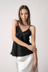 Model wearing black silk camisole top by Silk Closet in studio. Ivory silk skirt.