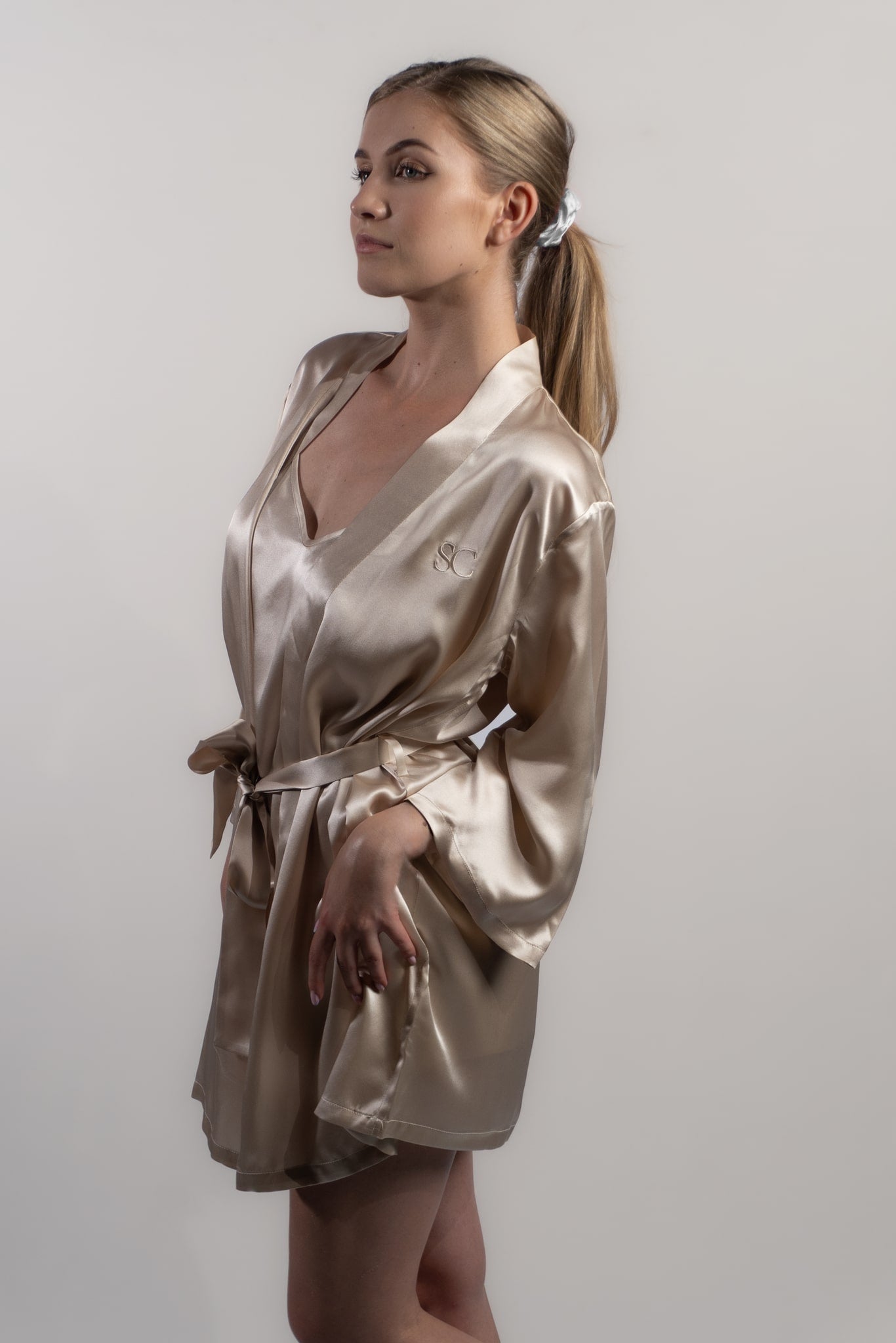 Woman wearing champagne silk robe or kimono. Pure silk. Perfect for special events such as weddings