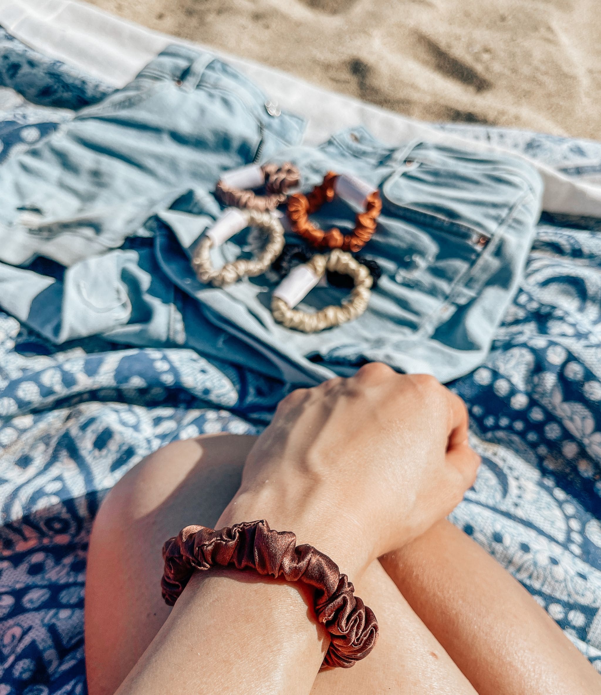 Silk Closet silk Angelina brown hair midi scrunchie.  Gentle hold for healthy hair.  On wrist at the beach.