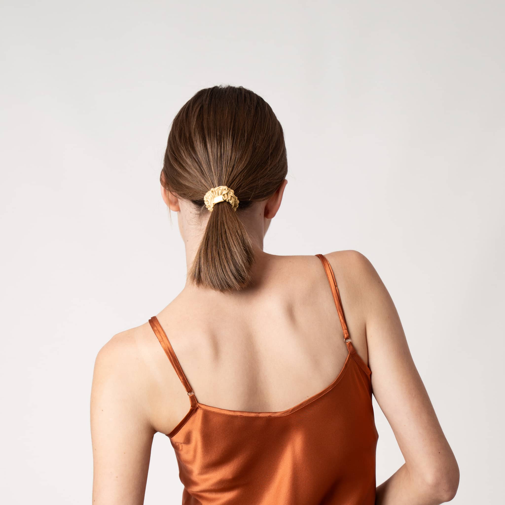 Woman wearing Silk Closet gold silk hair scrunchie