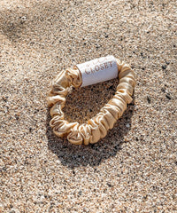 Silk Closet gold silk hair scrunchie on sand