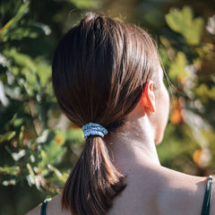 Woman wearing blue silk closet scrunchie