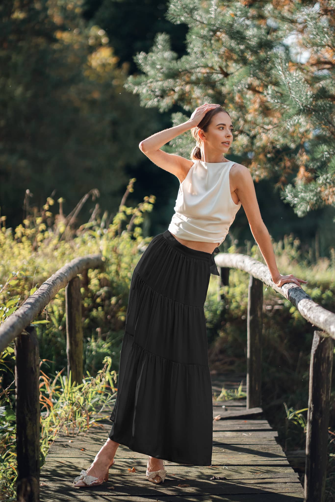 Woman wearing Silk Closet tiered Maxi skirt in sandwashed silk black outdoors