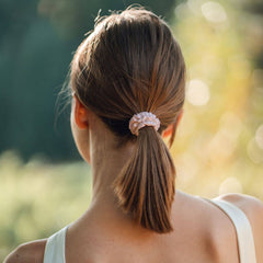 Woman wearing silk closet pink scrunchie