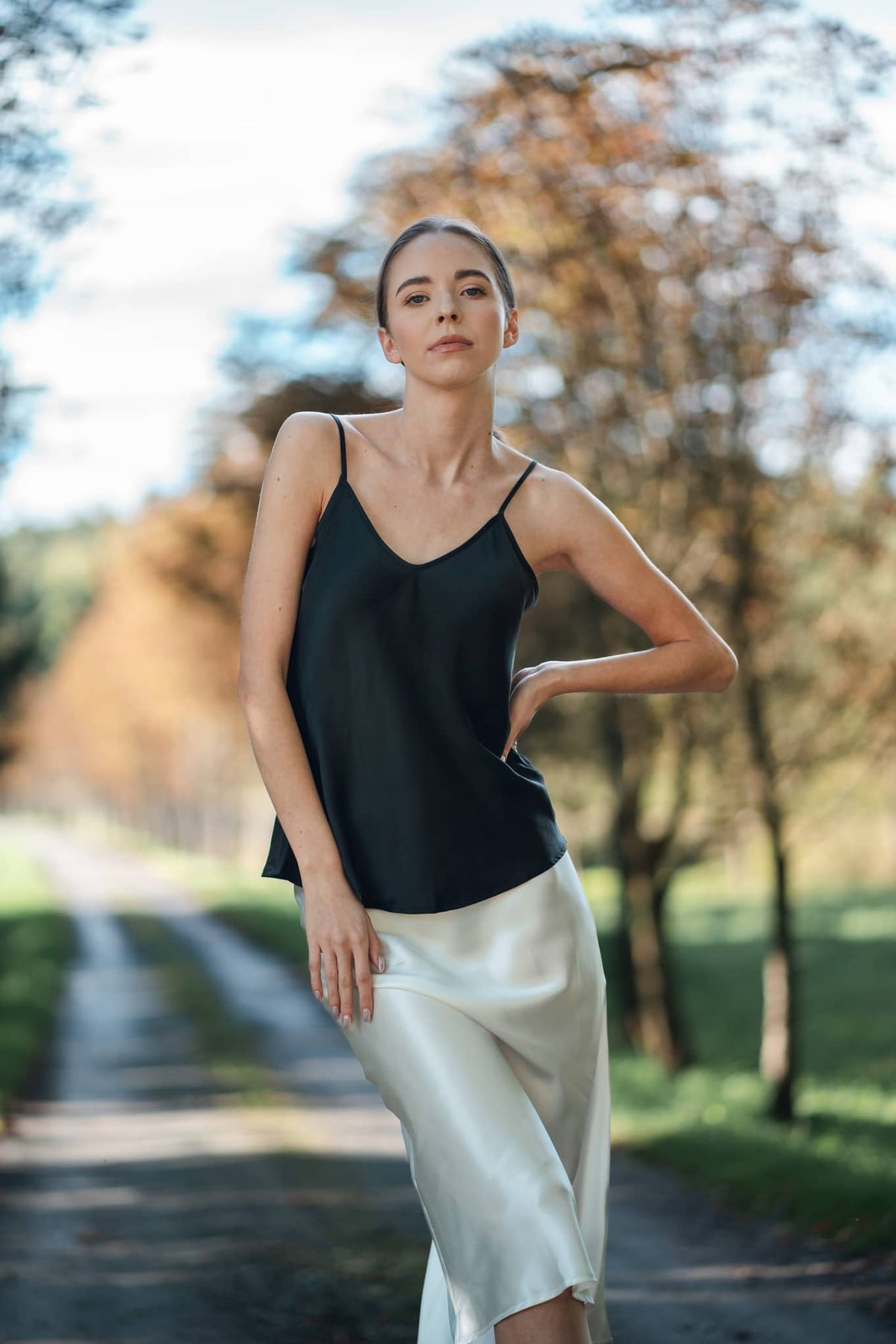 Model wearing black silk camisole top by Silk Closet. Ivory silk skirt