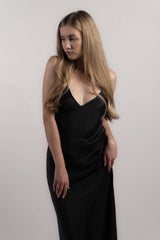 Woman wearing black silk closet classic slip dress in studio. Sandwashed finish.