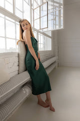 Woman wearing Silk Closet Cowl neck sandwash silk green dress. Side view.