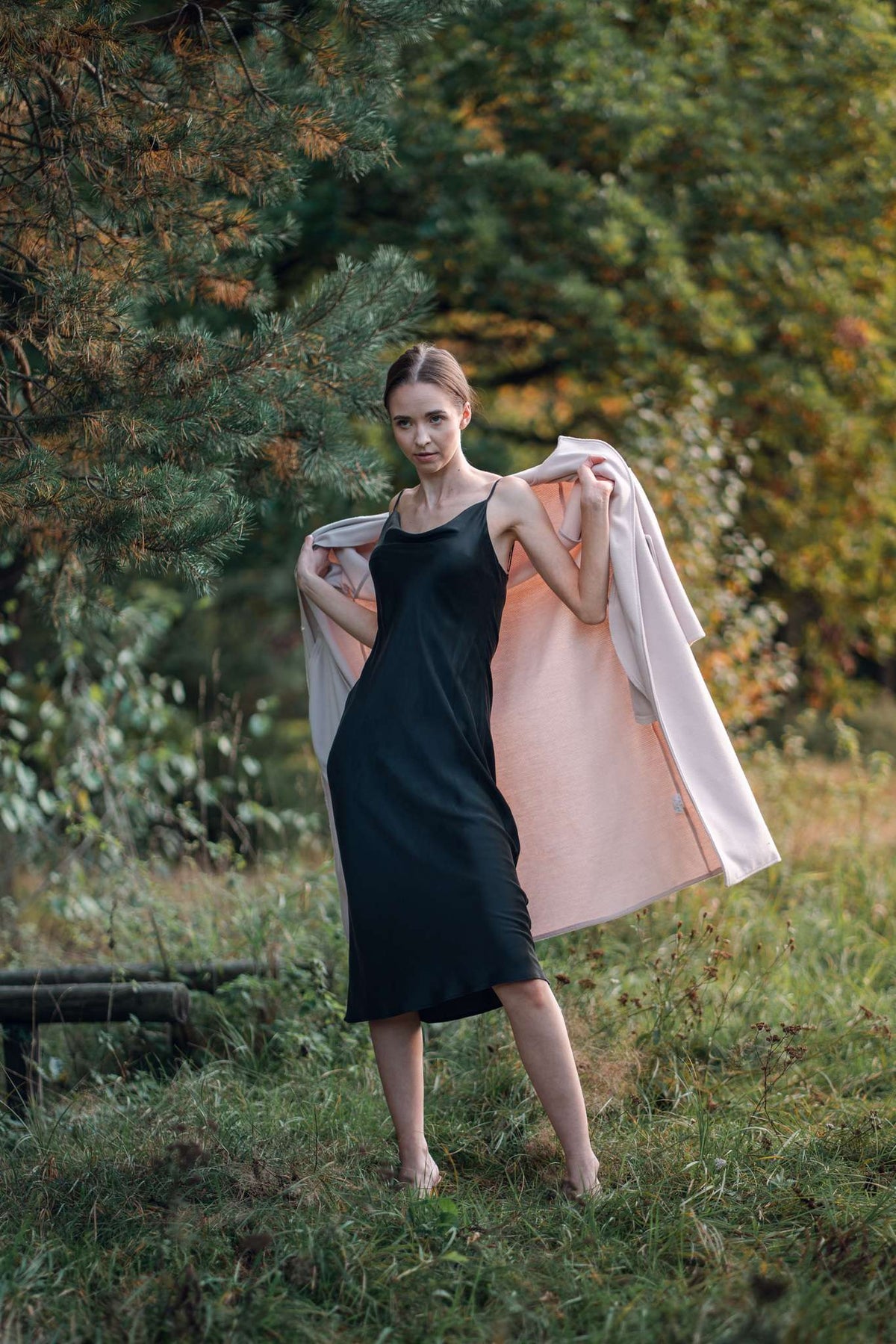 Woman wearing cowl neck black silk dress by Silk Closet outdoors