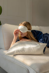 Silk Closet whitehaven bliss silk pillowcase for beauty sleep. Woman lying on it with eye mask